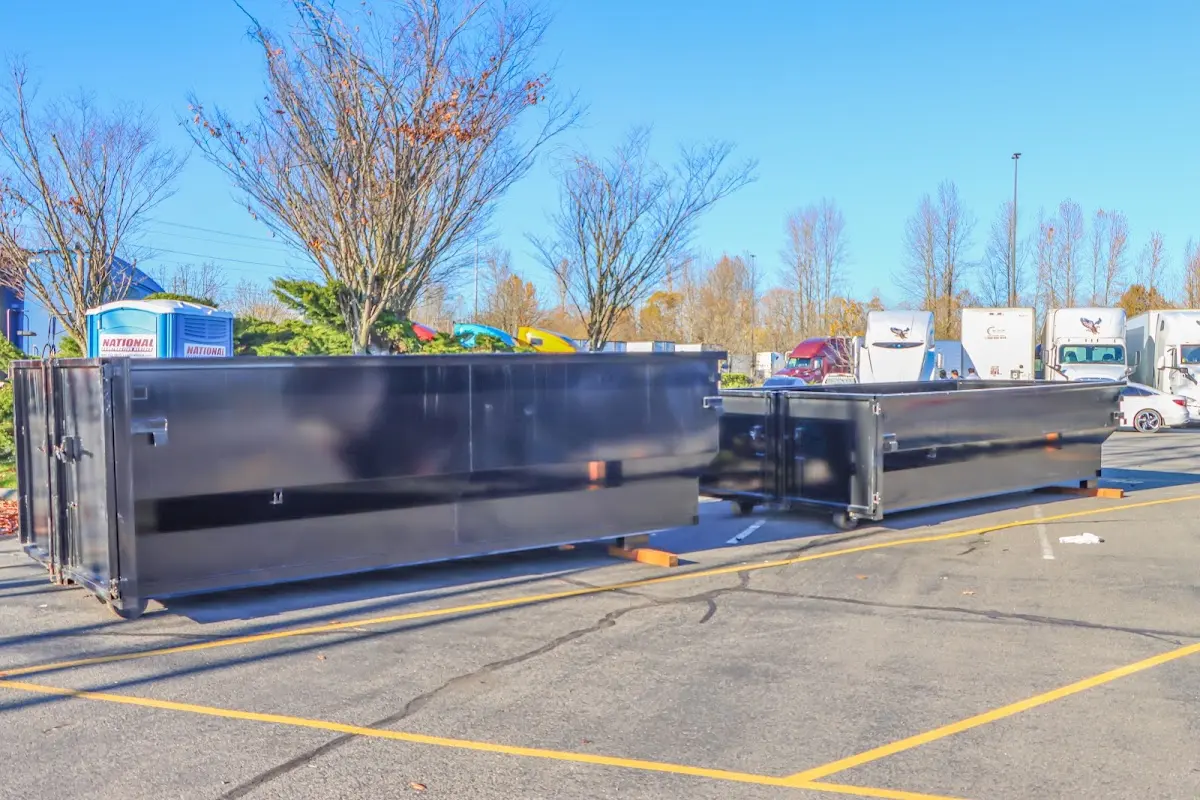 Professional dumpster rental service with roll-off container on residential driveway in Berkeley